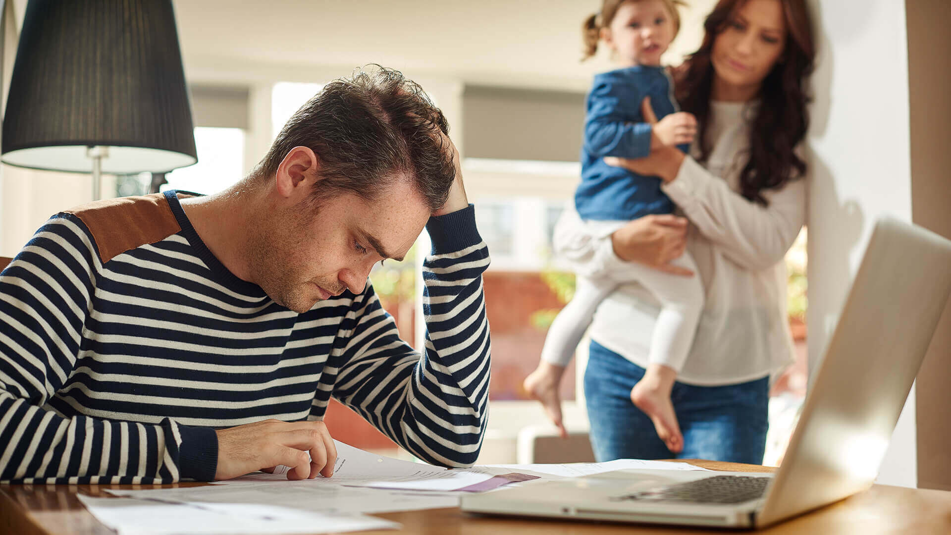 dad-looking-sad-with-family-iStock-495373616 theinvestmentnews.com